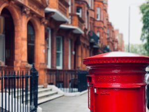red mail box on street during daytime