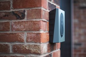 a close up of a brick wall with a speaker on it