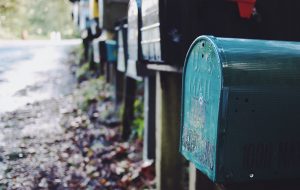 tilt shift photography of green mailbox