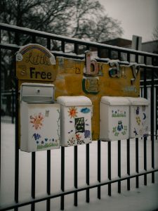 a bunch of refrigerators that are on a fence